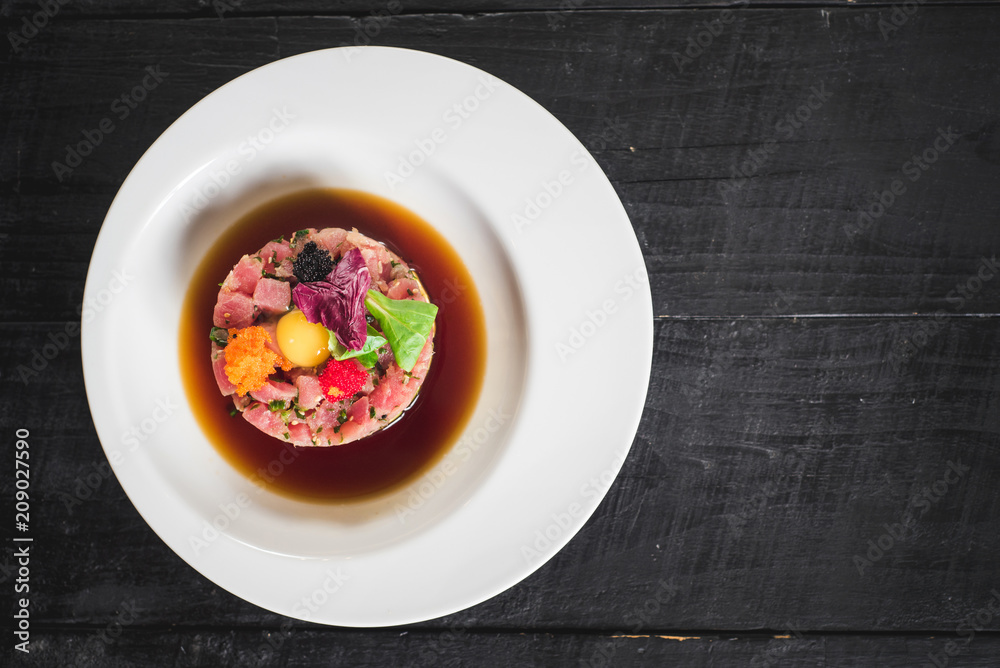 Tasty tartar salad on black background Tasty tartar salad on black background