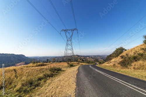 Overhead Pylon and Powerlines Next to Asphalt Road