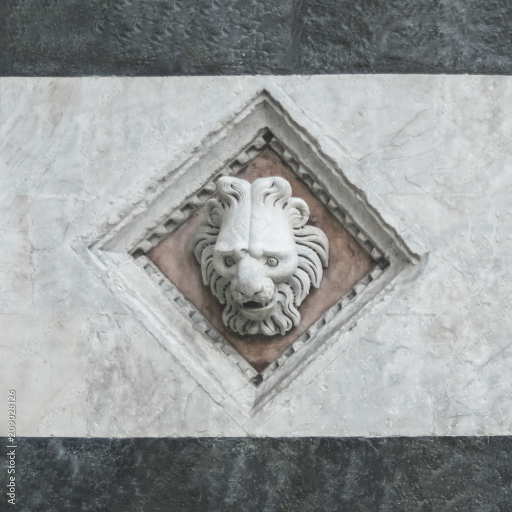 bas-relief of a lion on a stone wall
