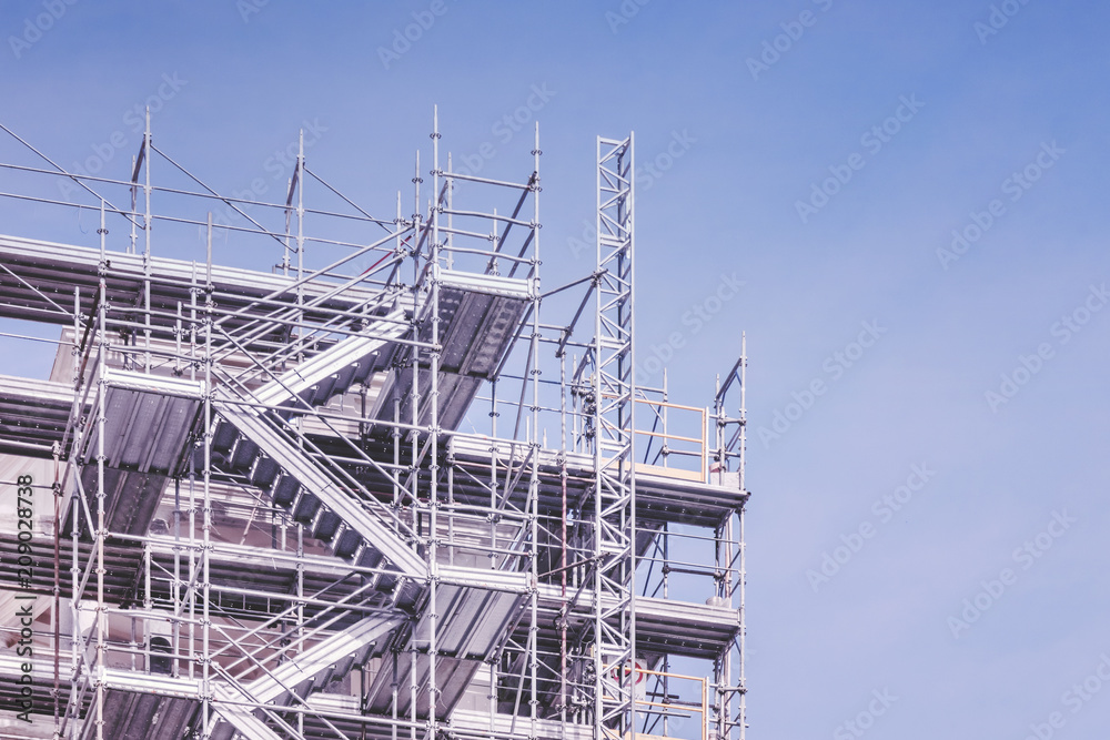 Building under construction against the blue sky