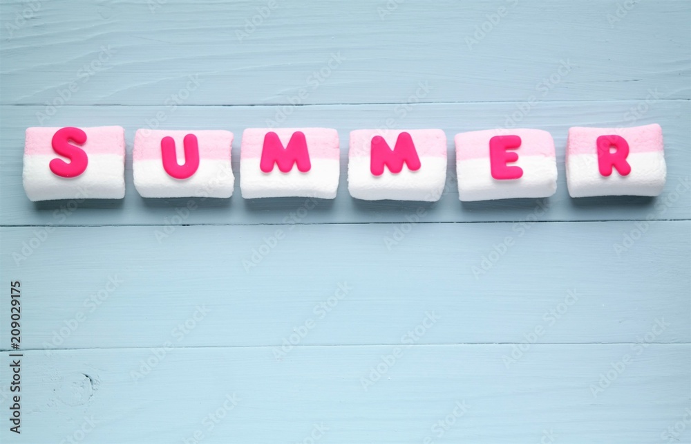 summer concept with pink letters, marsmallows, blue background color and copy space summer concept with pink letters, marsmallows, blue background color and copy space
