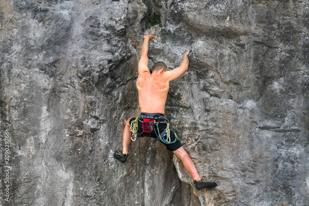 rock climber climbs on a rocky wall without insurance rock climber climbs on a rocky wall without insurance