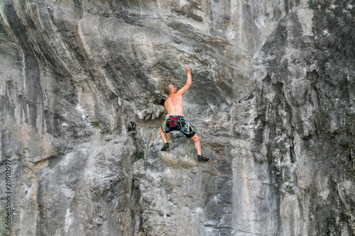 Rock climber on the cliff without insurance equipment
