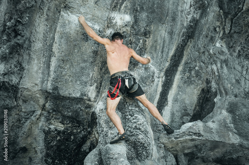 Young male climber on the cliff