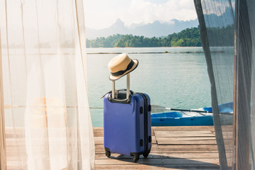 Traveling suitcase on the floor with cap out the room, travel lifestyle concept, Time to Relax.