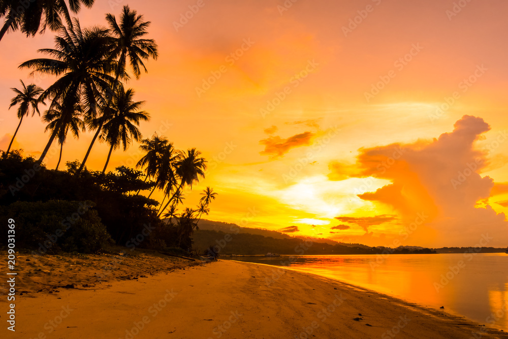 Beautiful outdoor view ocean and beach with tropical coconut palm tree at sunrise time
