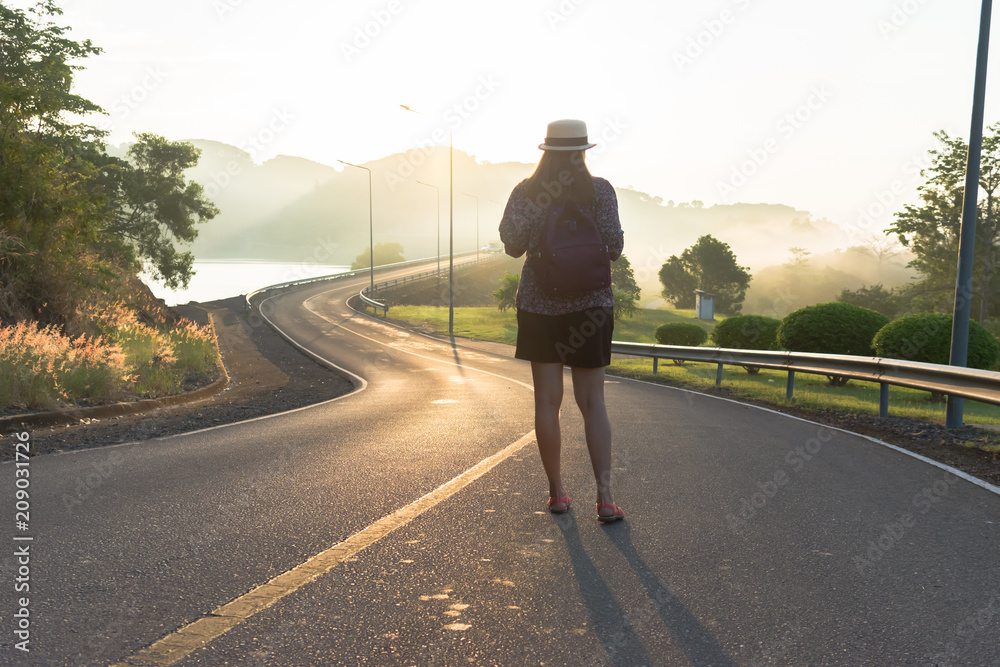 Back view of young woman with beautiful landscape, backpack travel around the world concept.