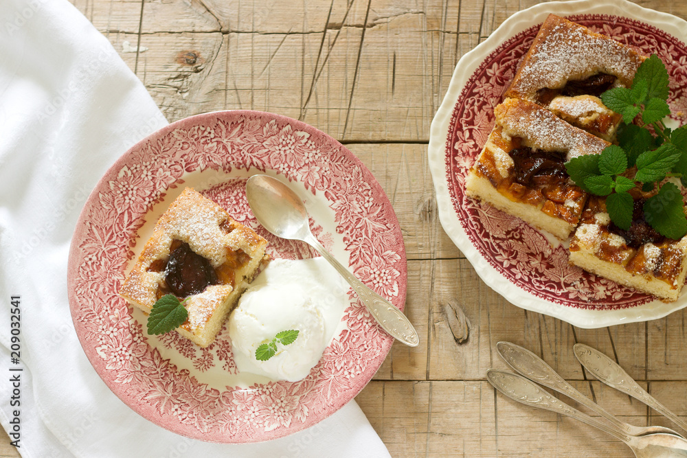 Pie with plums and peaches, served with a vanilla ice cream ball and lemon balm leaves. Pie with plums and peaches, served with a vanilla ice cream ball and lemon balm leaves.