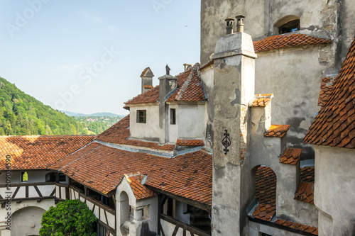 walls and towers of Bran Castle and the sunny Carpathian Mountains. The legendary residence of Drakula in the Carpathian Mountains, Romania