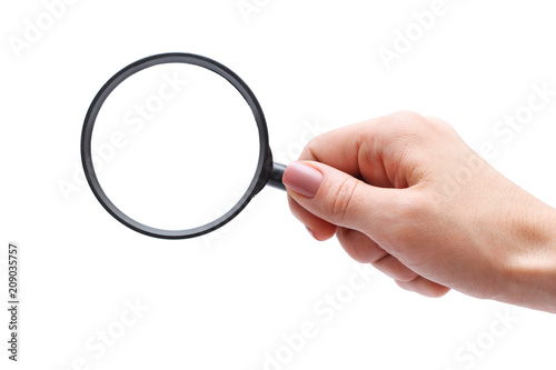Female hand with magnifying glass. 