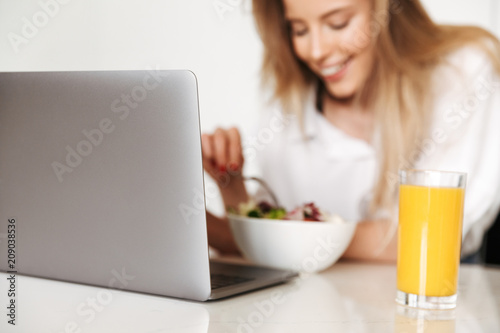 Close up of happy woman eating salad