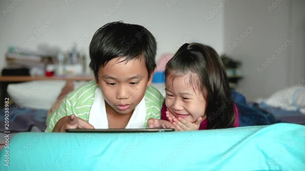Asian children using digital tablet. E-learning concept. Asian children using digital tablet. E-learning concept.