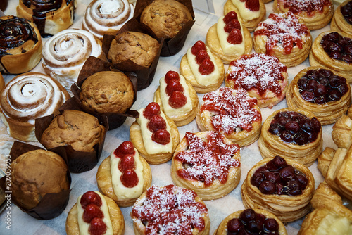 Photography Rows of a variety of cooked desserts close-up in the display case