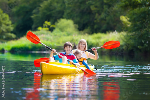 Child on kayak. Kids on canoe. Summer camping.