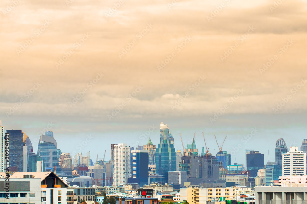 Bird view over cityscape with sun and clouds in the morning.Copy space.Bangkok.Pastel tone