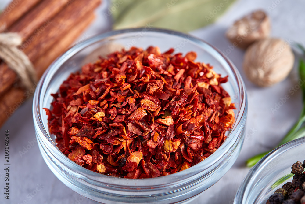 Transparent glass bowl with dried chilly among exotic spicies, close-up, top view, selective focus. Transparent glass bowl with dried chilly among exotic spicies, close-up, top view, selective focus.