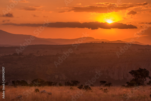 A golden orange sunset over the hills and savannah at Blyde River Canyon in Mpumalanga, South Africa