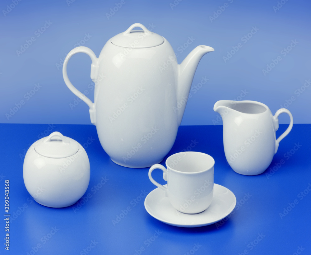 teapot, sugar bowl, cup, milk jug on light blue background
teapot, sugar bowl, cup, milk jug on light blue background