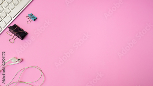 Earphones and paper cilp with keyboard on pink  background. Pastel color Minimal concept Copy space © boyhey