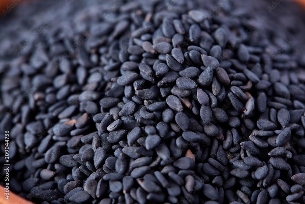 Black sesame seed background and textured, close-up, macro, shallow depth of field. Black sesame seed background and textured, close-up, macro, shallow depth of field.