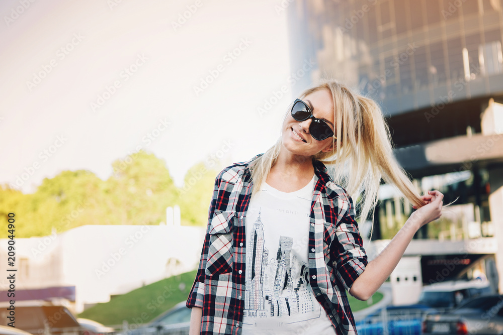 Fototapeta premium Young stylish pretty woman with sunglasses posing in the city streets. vacation europe.