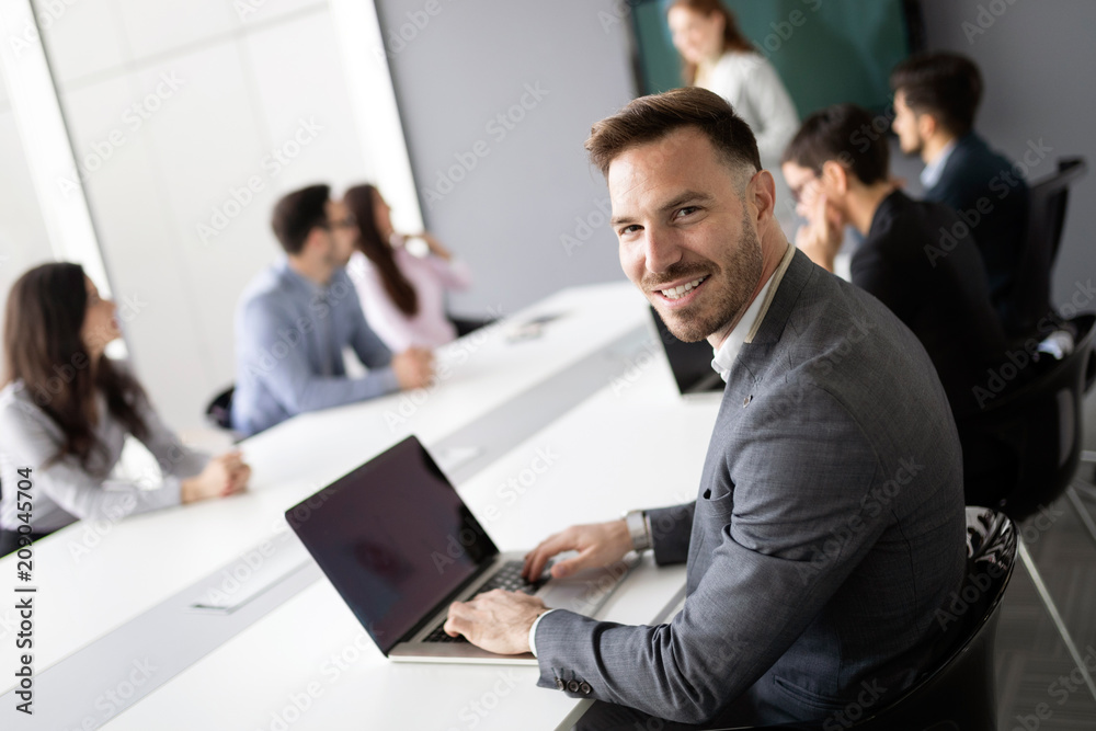 Portrait of handsome successful businessman holding tablet