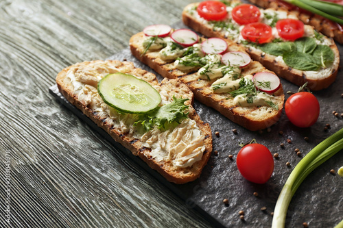 Delicious toasts on wooden table