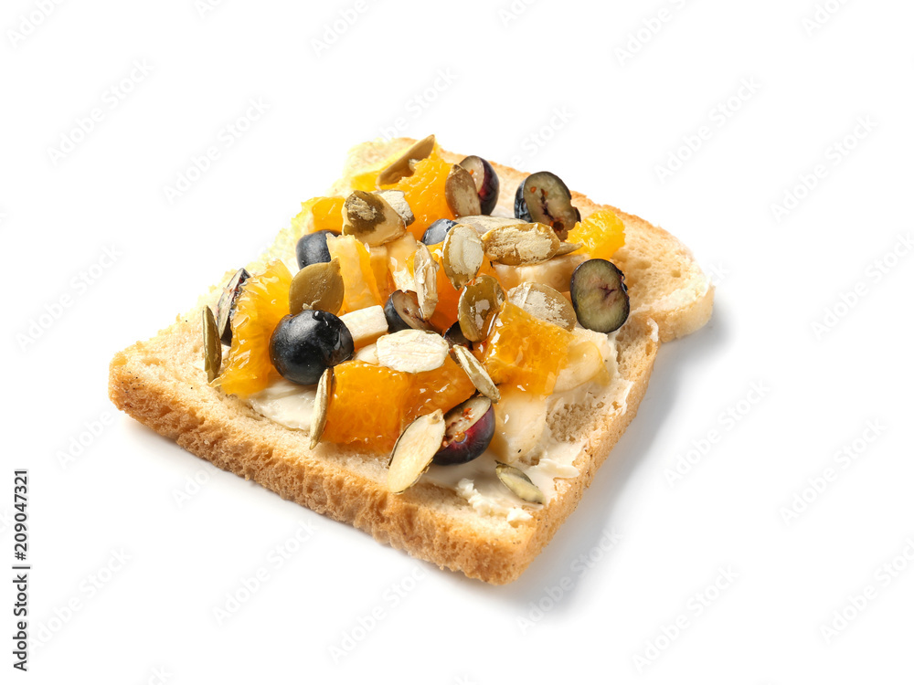 Tasty sweet toast with butter, blueberry, seeds and pieces of fruits on white background Tasty sweet toast with butter, blueberry, seeds and pieces of fruits on white background