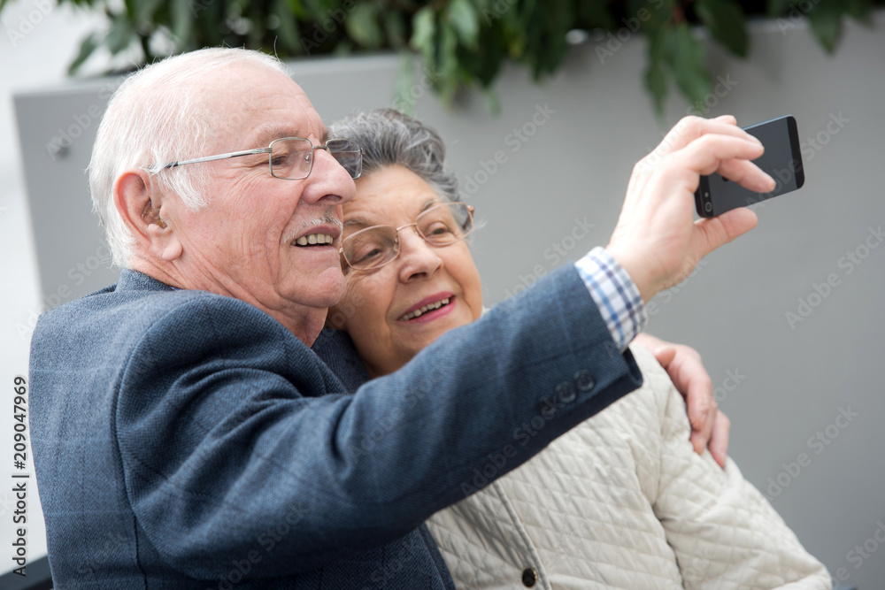 senior couple taking selfie with mobile senior couple taking selfie with mobile