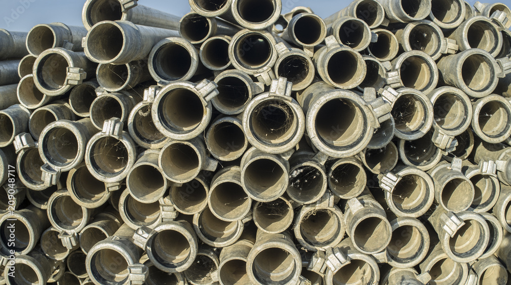 Irrigation metal pipes stacked outdoors out of watering season Irrigation metal pipes stacked outdoors out of watering season