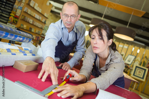 craftswoman working on frame in frame shop