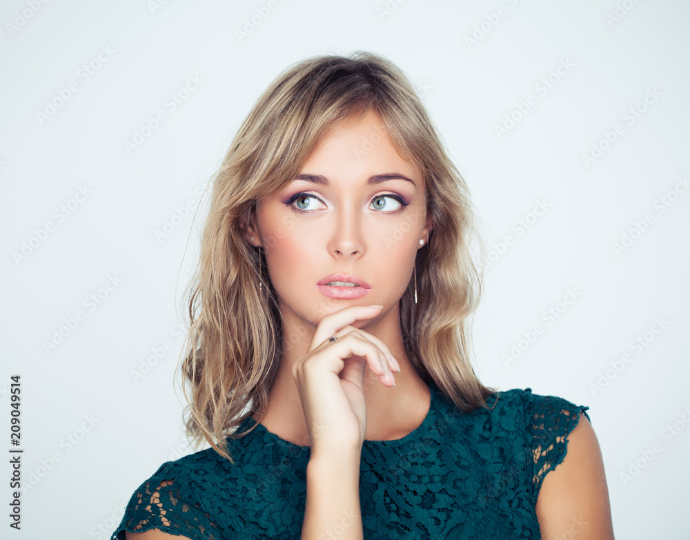 Thinking woman with her hand at her face Thinking woman with her hand at her face