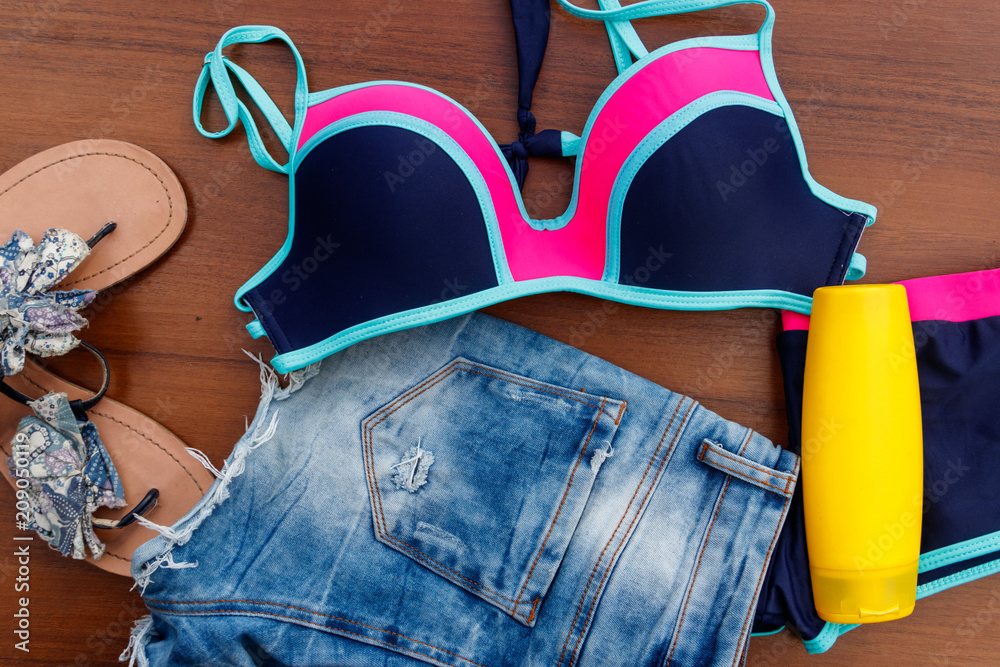 Set of beachwear on wooden background Set of beachwear on wooden background
