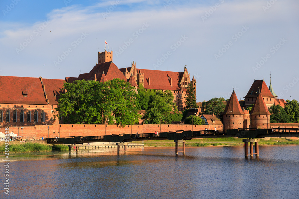 The wooden pedestrian bridge on the background of Teutonic Castle in Malbork, Poland