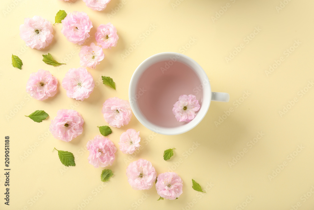 Composition with cup and blossoming flowers on color background Composition with cup and blossoming flowers on color background