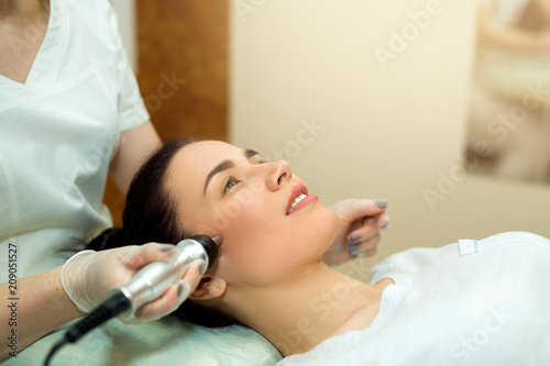 beautiful young girl on a facial treatment in a beauty salon