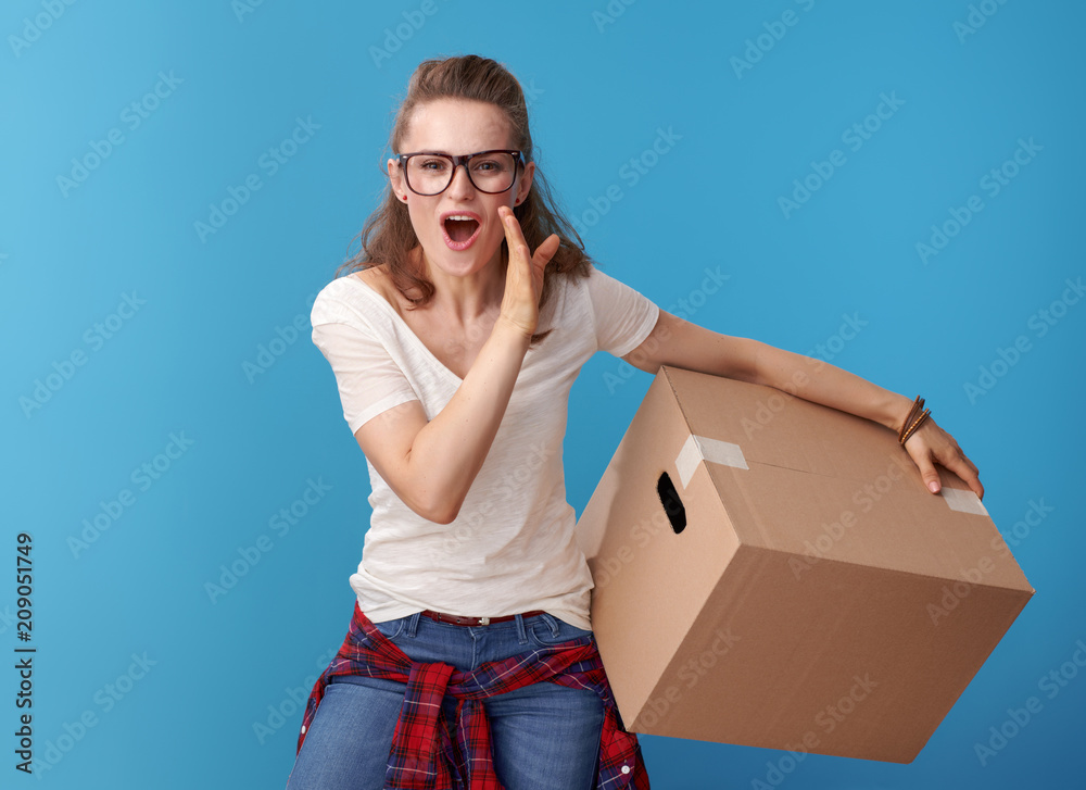 happy woman with cardboard box telling exciting news on blue happy woman with cardboard box telling exciting news on blue