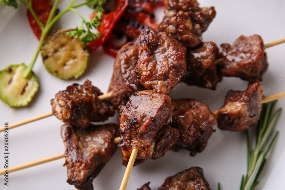 Barbecue skewers with juicy meat on plate