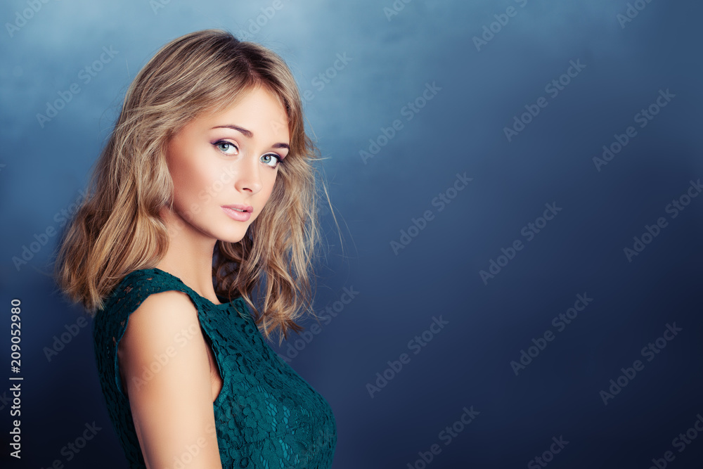 Cute female model smiling on blue background with copy space. Young woman face Cute female model smiling on blue background with copy space. Young woman face