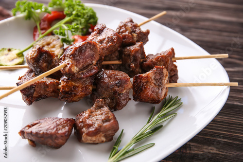 Grilled meat skewers on whi...
