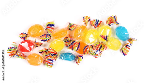 Colorful candies with transparent cellophane wrapping isolated on white background, top view
