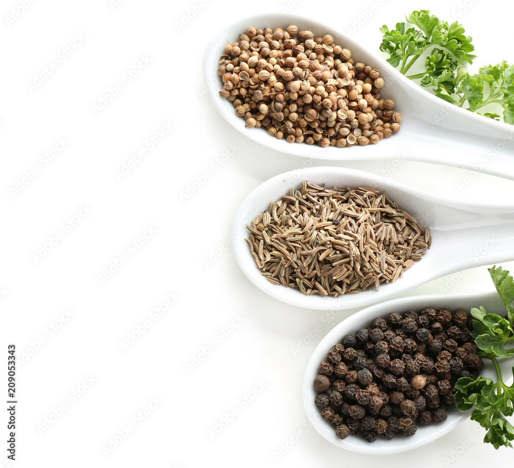 Spoons with various spices on white background Spoons with various spices on white background
