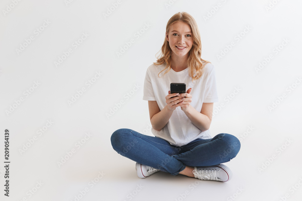 © Drobot Dean - Pretty young cute redhead woman using mobile phone. © Drobot Dean - Pretty young cute redhead woman using mobile phone.
