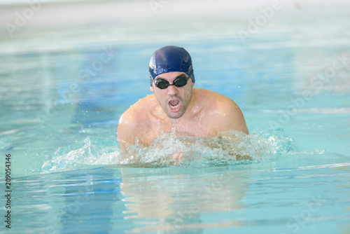 man swimmer swimming crawl in swimming pooltraining for triathlon