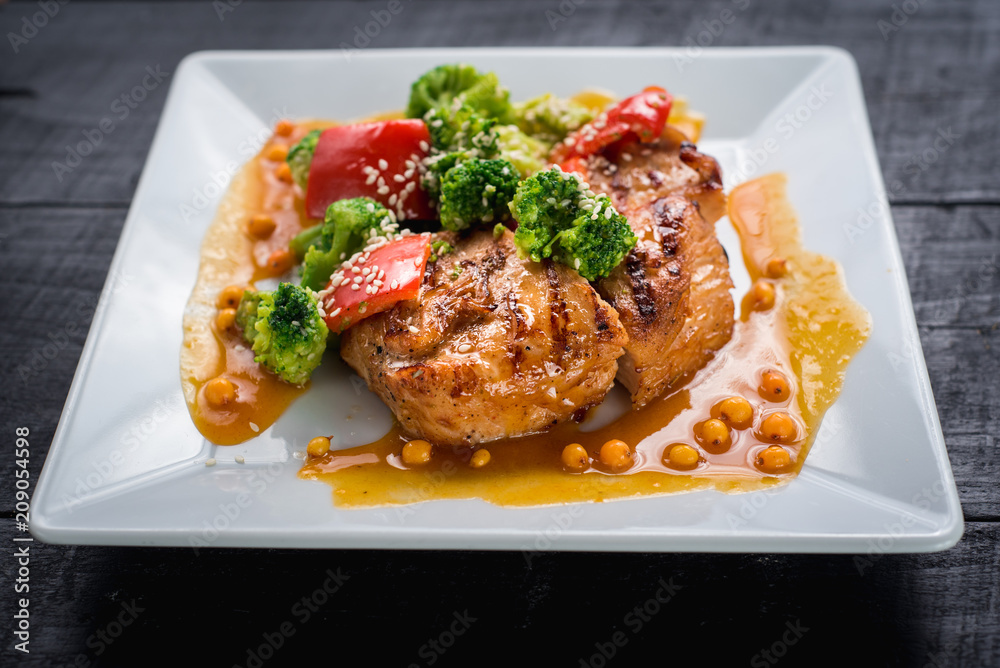 Tasty fried chicken meat with vegetables and lentils sauce on wooden background Tasty fried chicken meat with vegetables and lentils sauce on wooden background