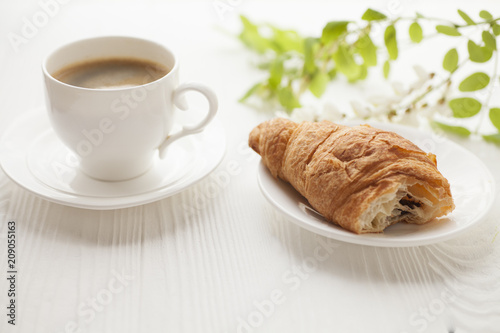 Fototapeta Naklejka Na Ścianę i Meble -  Coffee cup and fresh baked croissants on wooden background. Top View