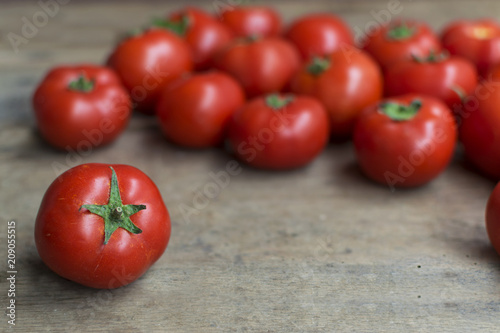 Fresh, red tomatoes on old wooden background