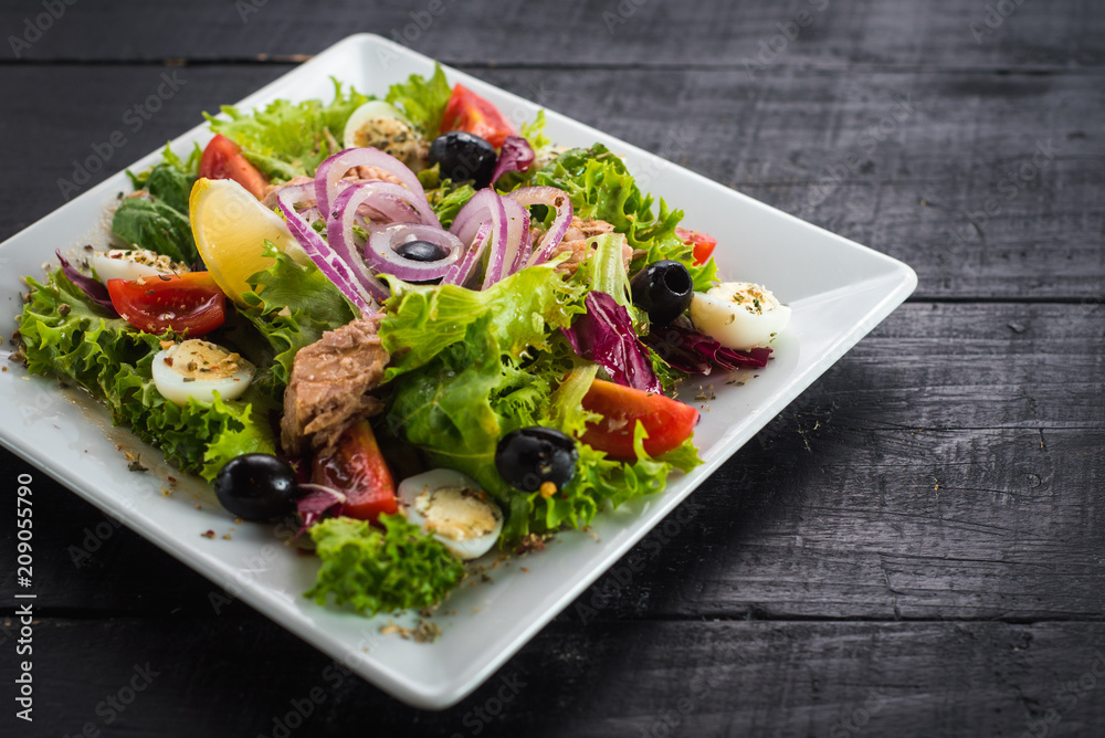 Salad with pieces of meat and vegetables on wooden background Salad with pieces of meat and vegetables on wooden background