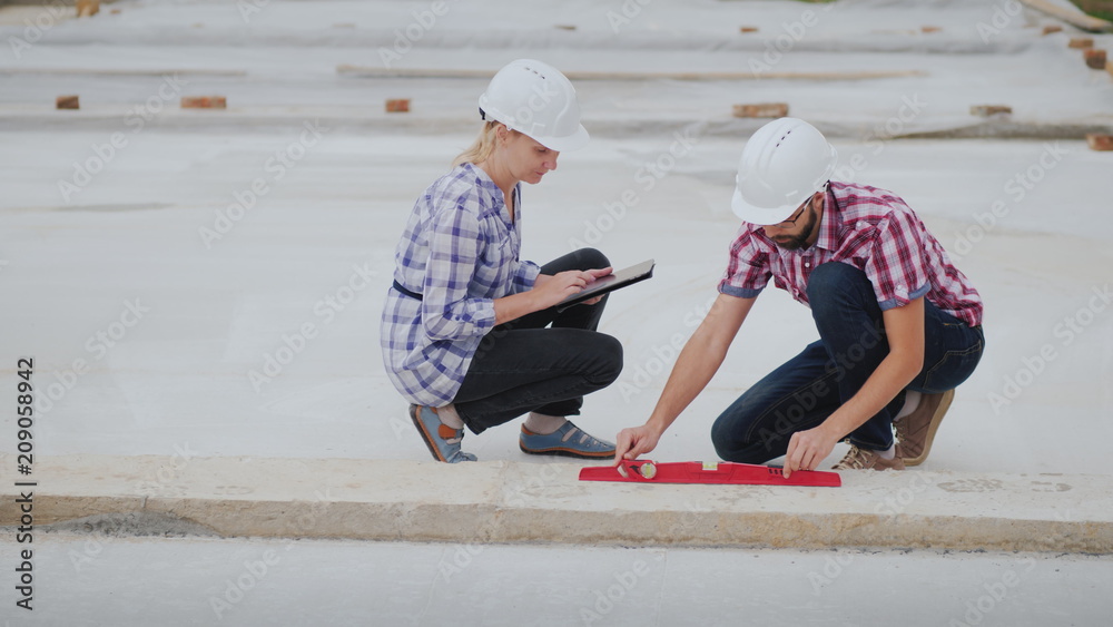 The quality control inspector checks the accuracy of building construction. Technical control in construction