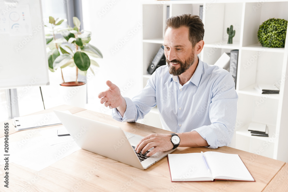 Confident businessman working on laptop computer Confident businessman working on laptop computer